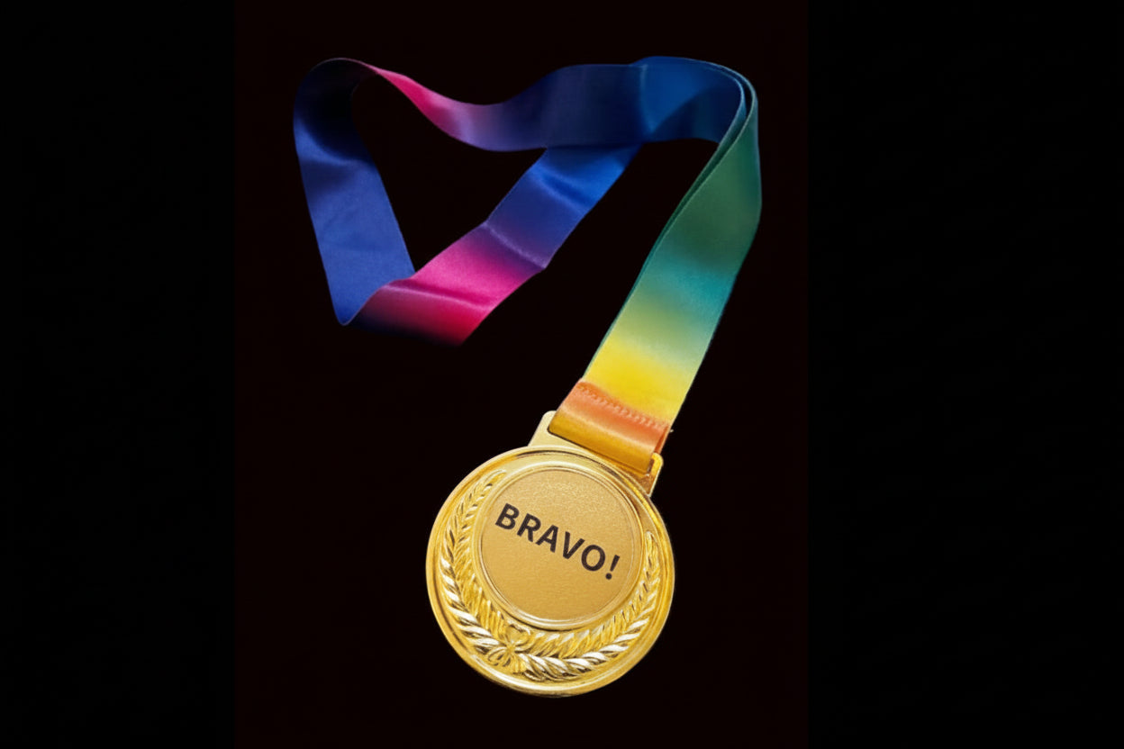 Gold medal with 'BRAVO!' text and a rainbow ribbon on a dark background